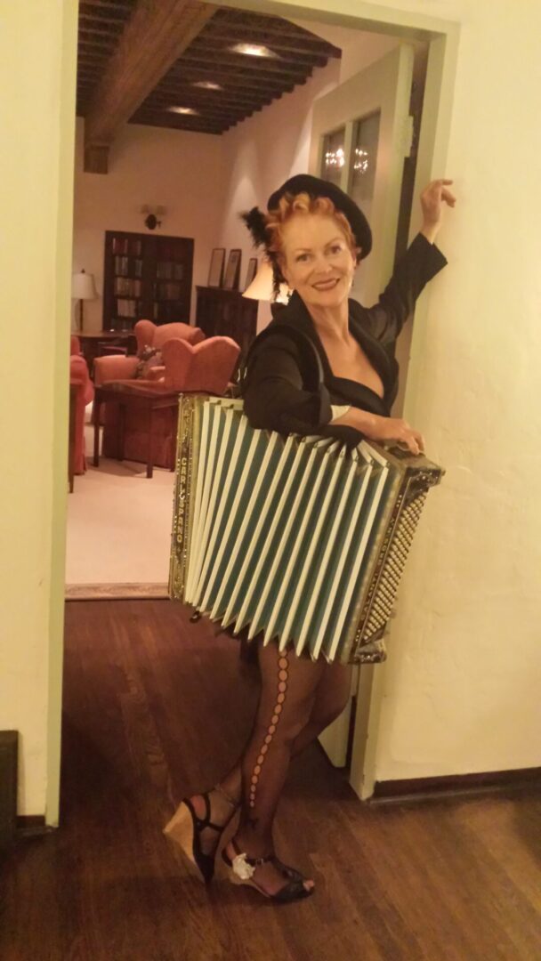 A woman posing with an accordion